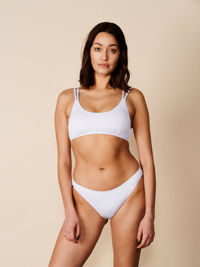 Female wearing our Adrianna Bikini Bra in white. Seen from the front.